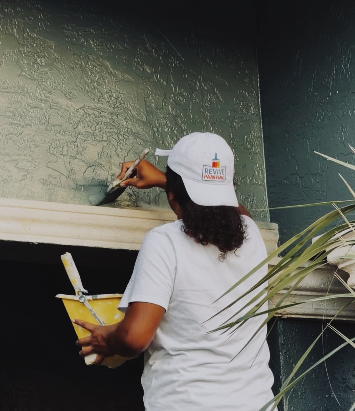 A Revive crew member carefully painting interior woodwork
